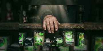 A person's hand reaching into a dimly lit market stall, attempting to decipher vague and misleading 'eco-friendly' labels on consumer products, illustrating greenwashing and consumer confusion.